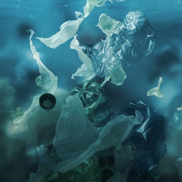 Toxic plastic waste floating underwater in the ocean, water pollution and environmental damage concept